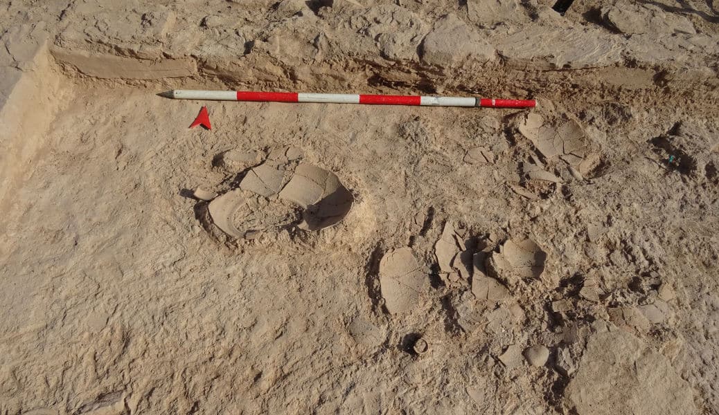 Scattering of pottery, specifically several jars, fallen onto the floor of one of the rooms.